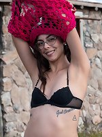 Eva One poses in her cap outside her home